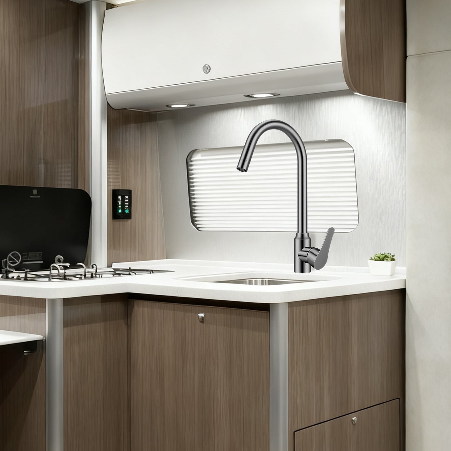 Modern kitchen interior with a sink, faucet, and wooden cabinets.