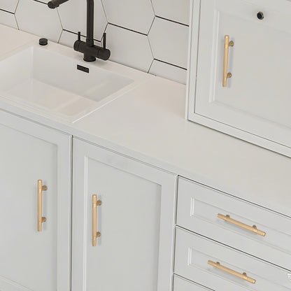 Bathroom vanity with white cabinets, gold handles, and a black faucet.
