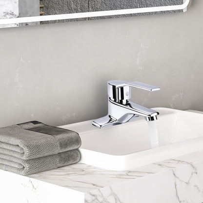 Chrome faucet on a marble sink with gray towels and a mirror in the background