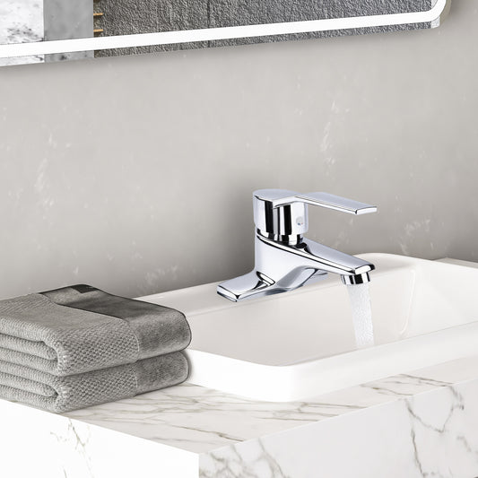 Chrome faucet on a marble sink with gray towels and a mirror in the background