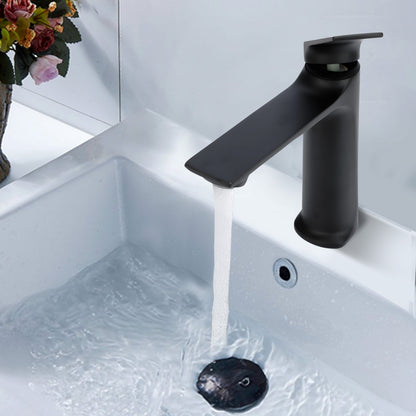 Black faucet with water flowing into a sink on a light gray background