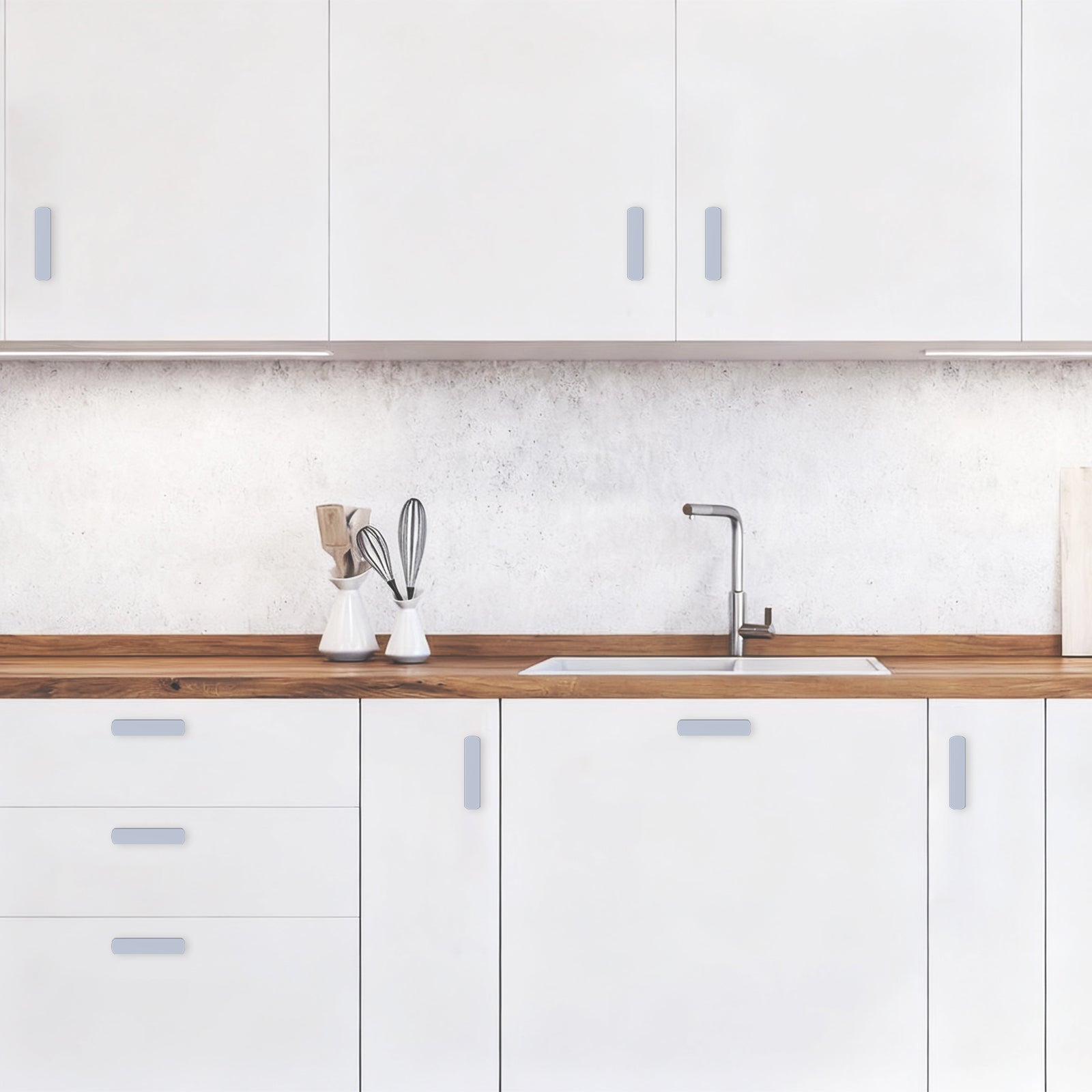 Modern kitchen with white cabinets, wooden countertop, and sink.