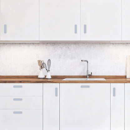 Modern kitchen with white cabinets, wooden countertop, and sink.