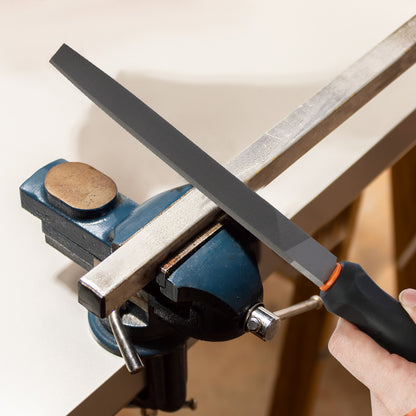 Person sharpening a knife on a whetstone held in a blue vise.