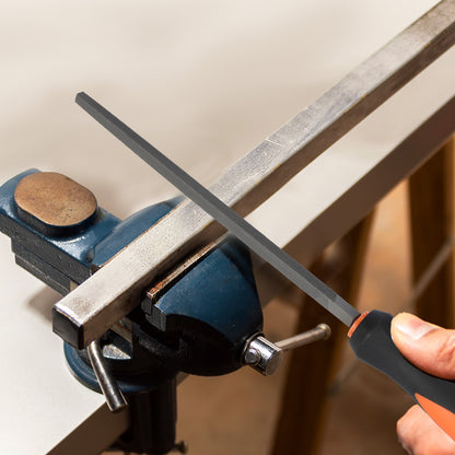 Person sharpening a blade on a metal rod using a sharpener attached to a bench vice.