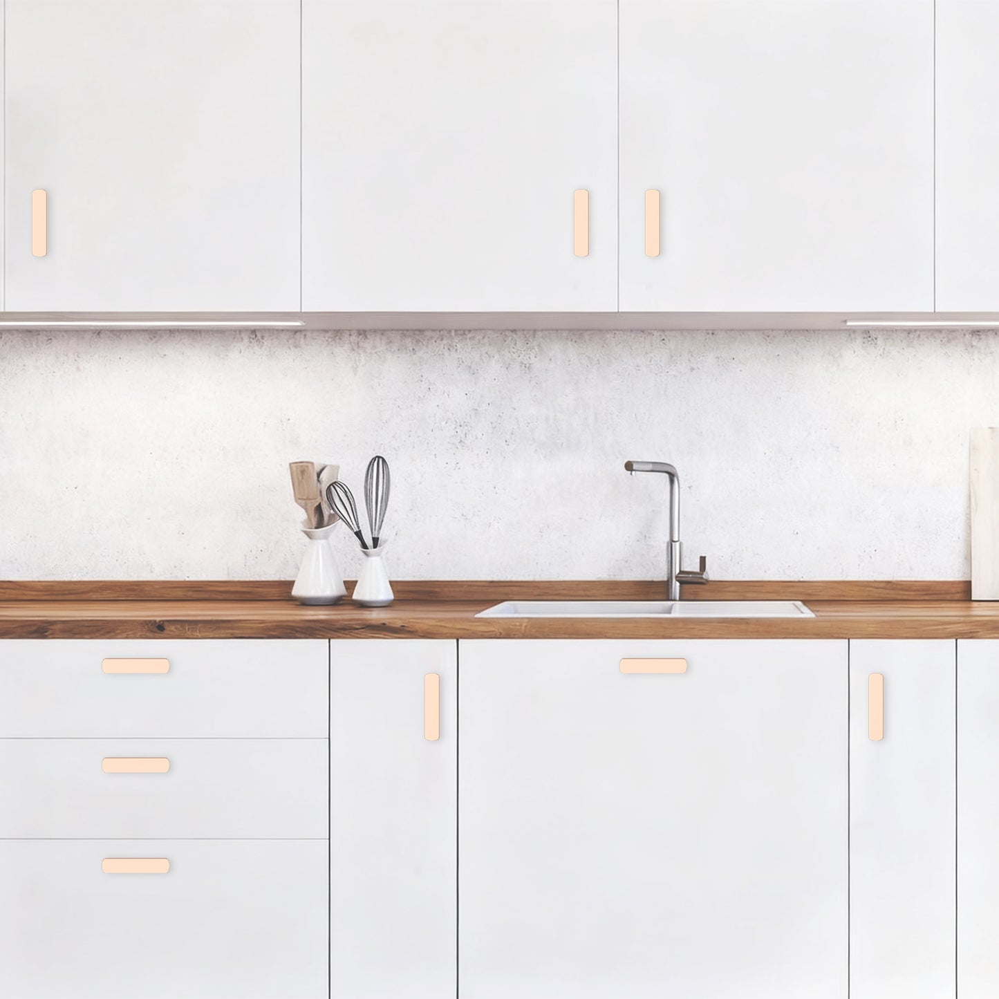 Modern kitchen with white cabinets, wooden countertop, and sink.