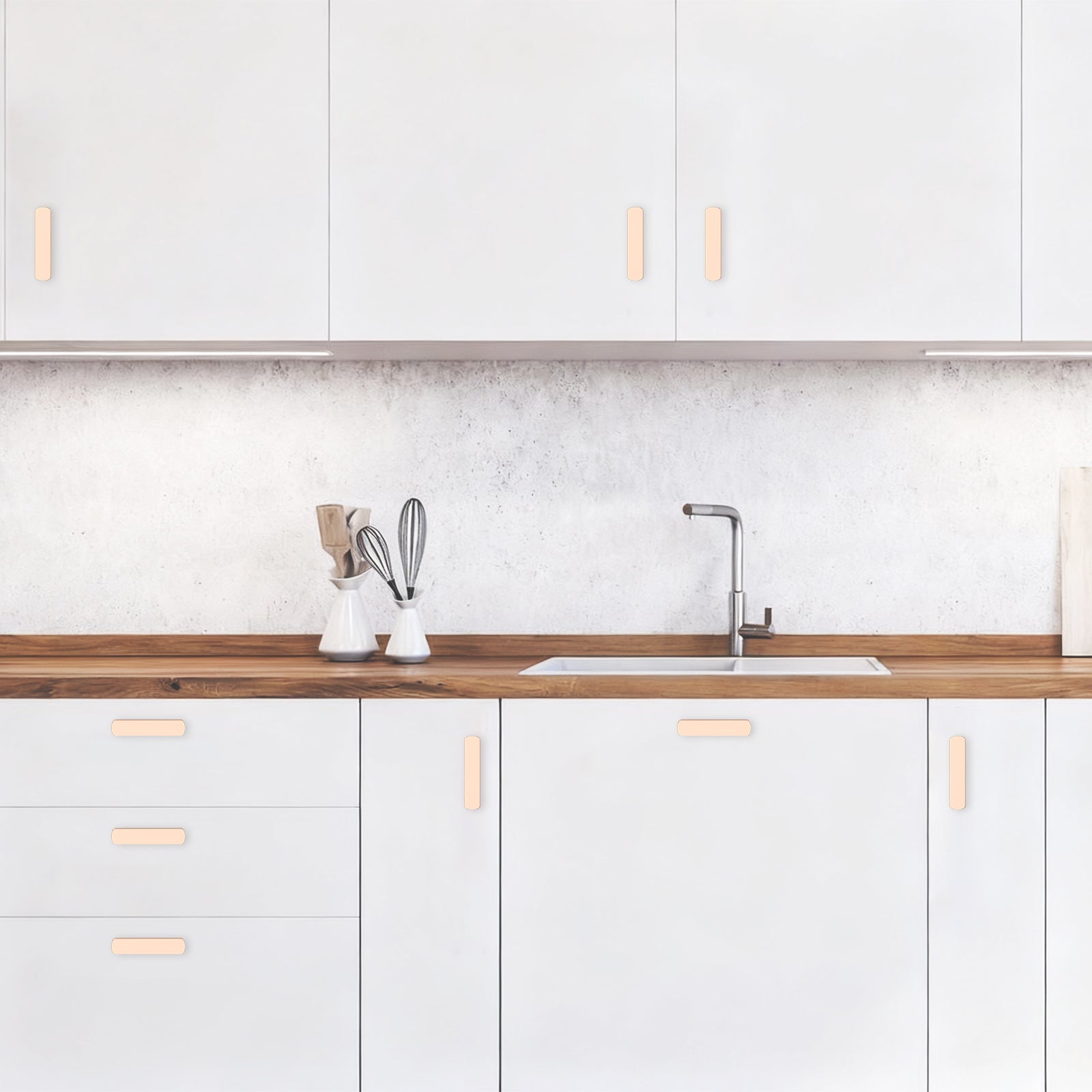 Modern kitchen with white cabinets, wooden countertop, and sink.
