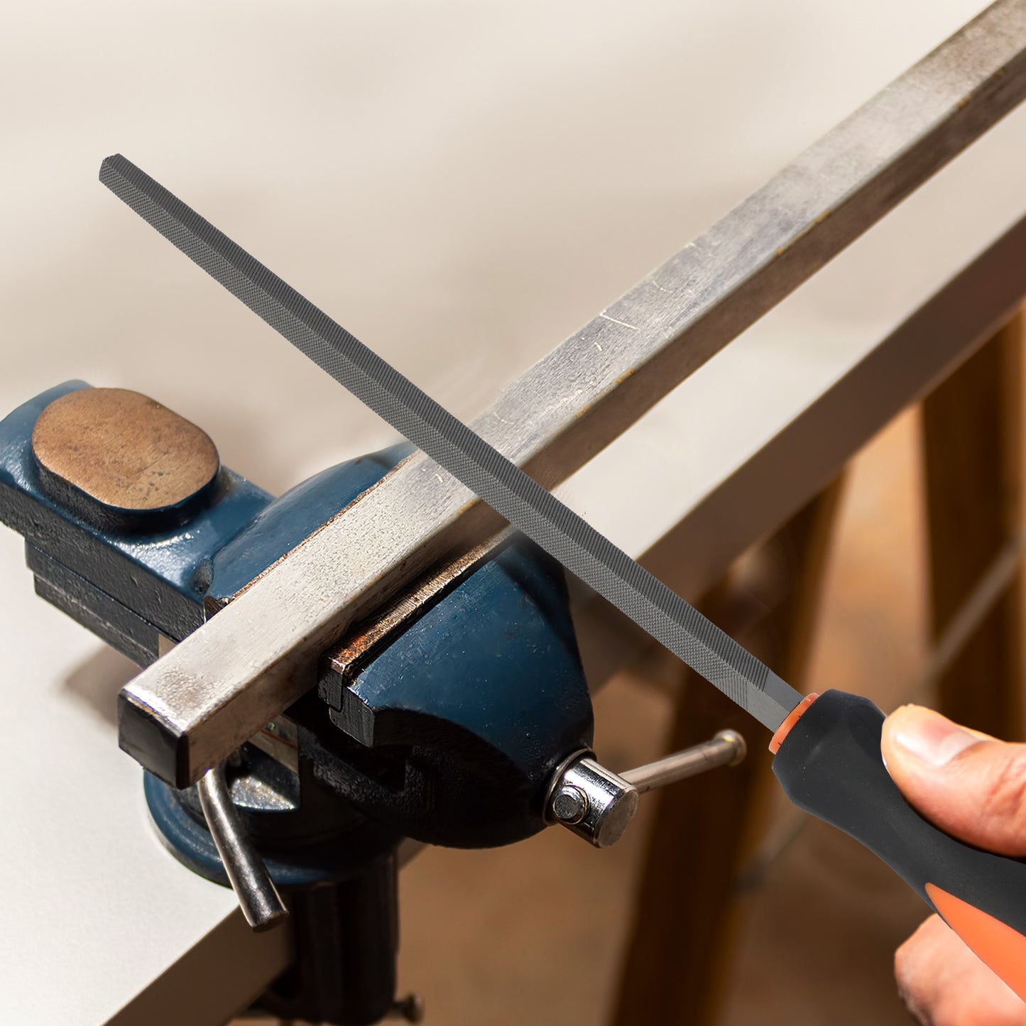 Person sharpening a knife on a metal rod using a sharpener attached to a clamp.