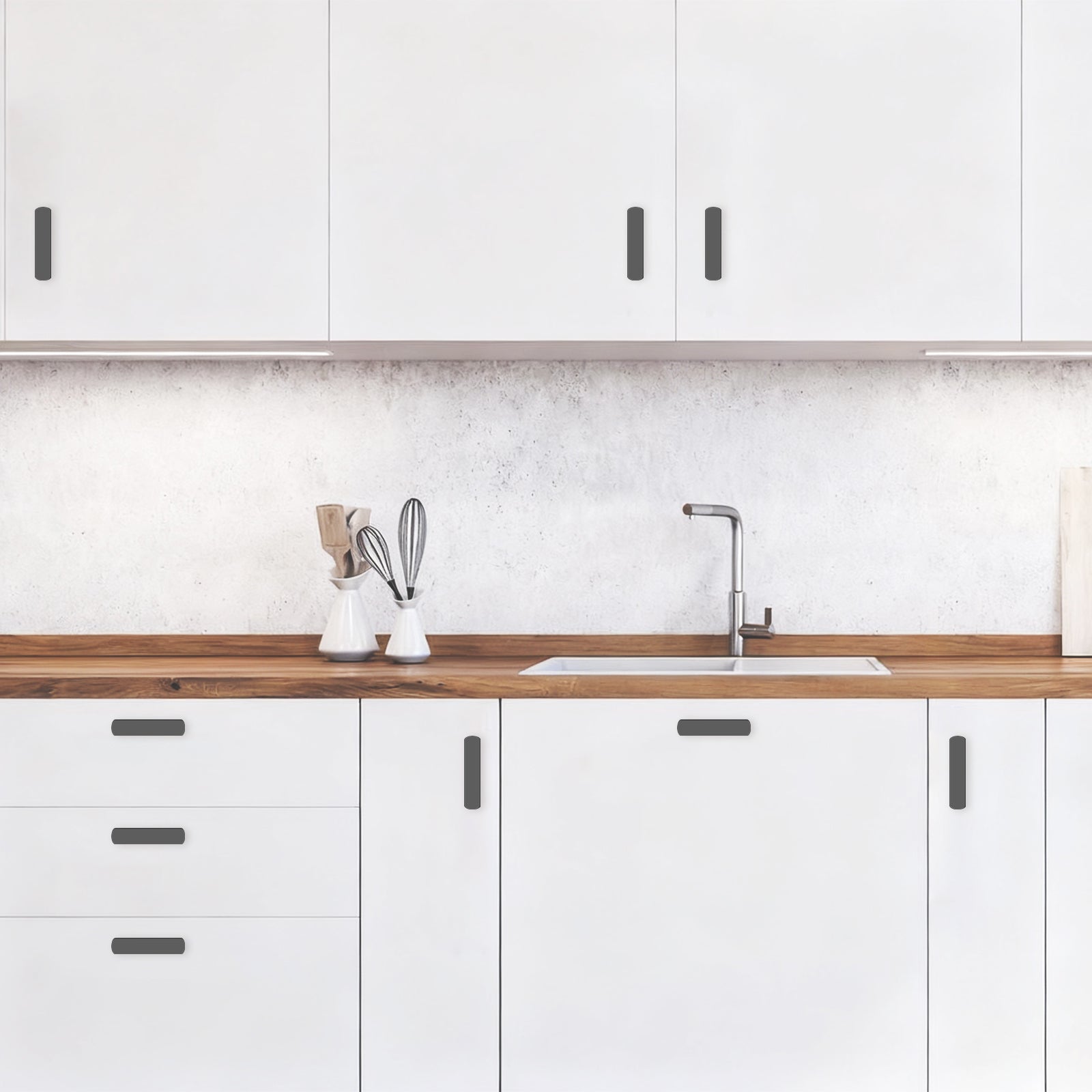 Modern kitchen with white cabinets, wooden countertop, and sink.