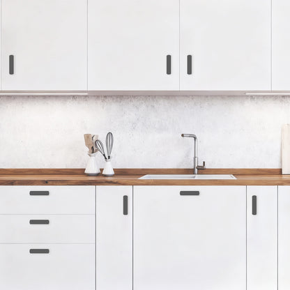 Modern kitchen with white cabinets, wooden countertop, and sink.