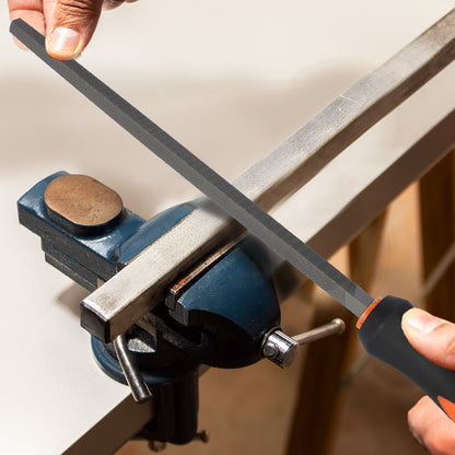 Person using a file to sharpen a metal rod held in a vise.