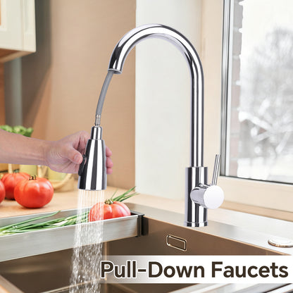 Pull-down faucet in a kitchen setting with a hand holding the nozzle.