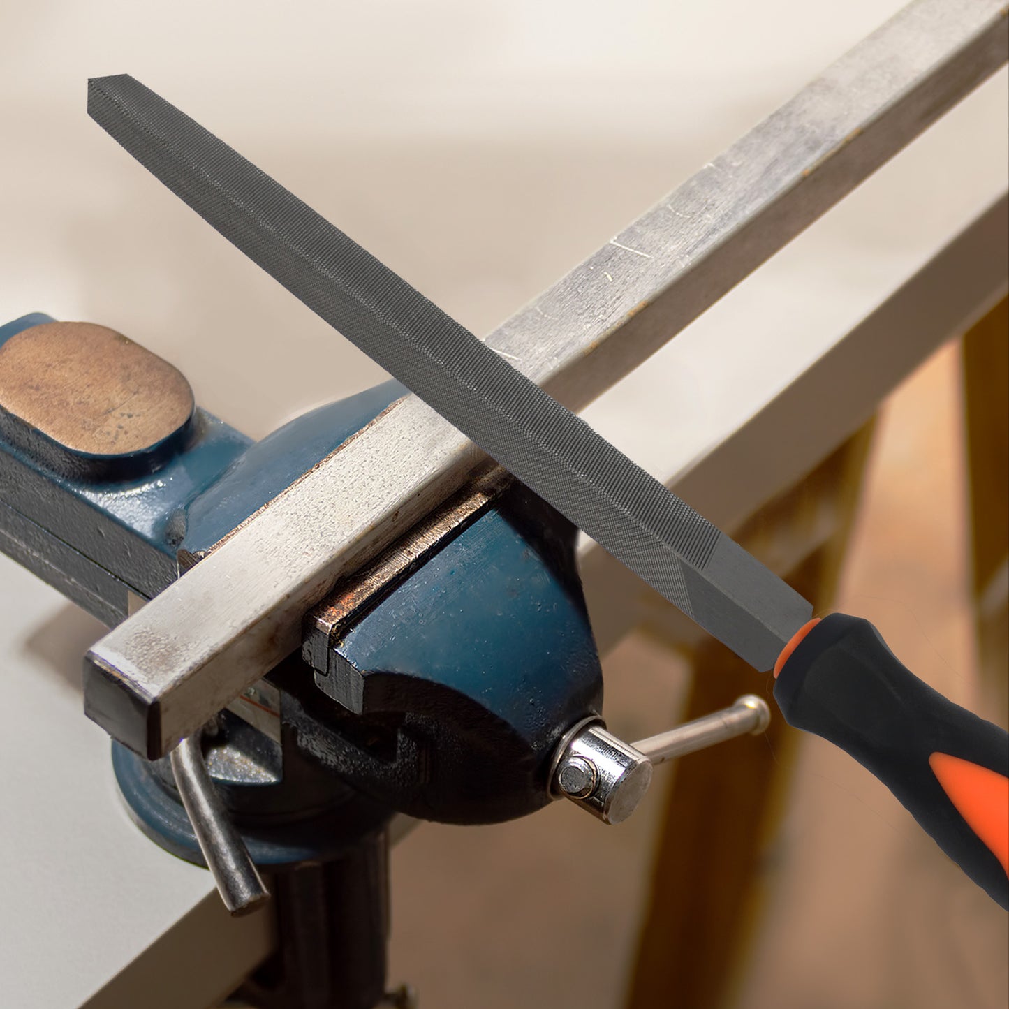 Metal file being used on a metal bar clamped in a vise