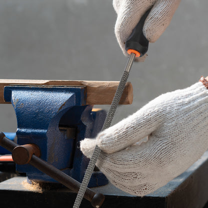 Person using a screwdriver on a blue vise with a blurred background