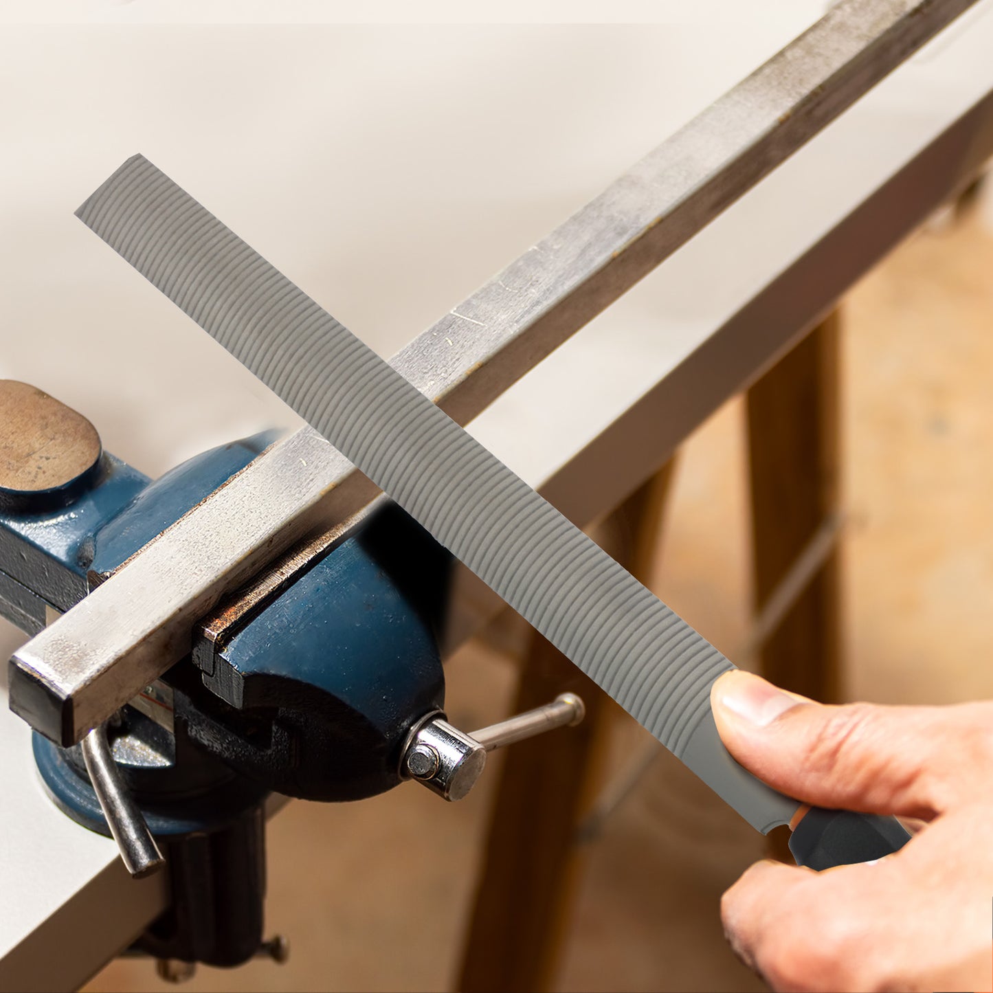 Person sharpening a blade with a whetstone on a wooden surface