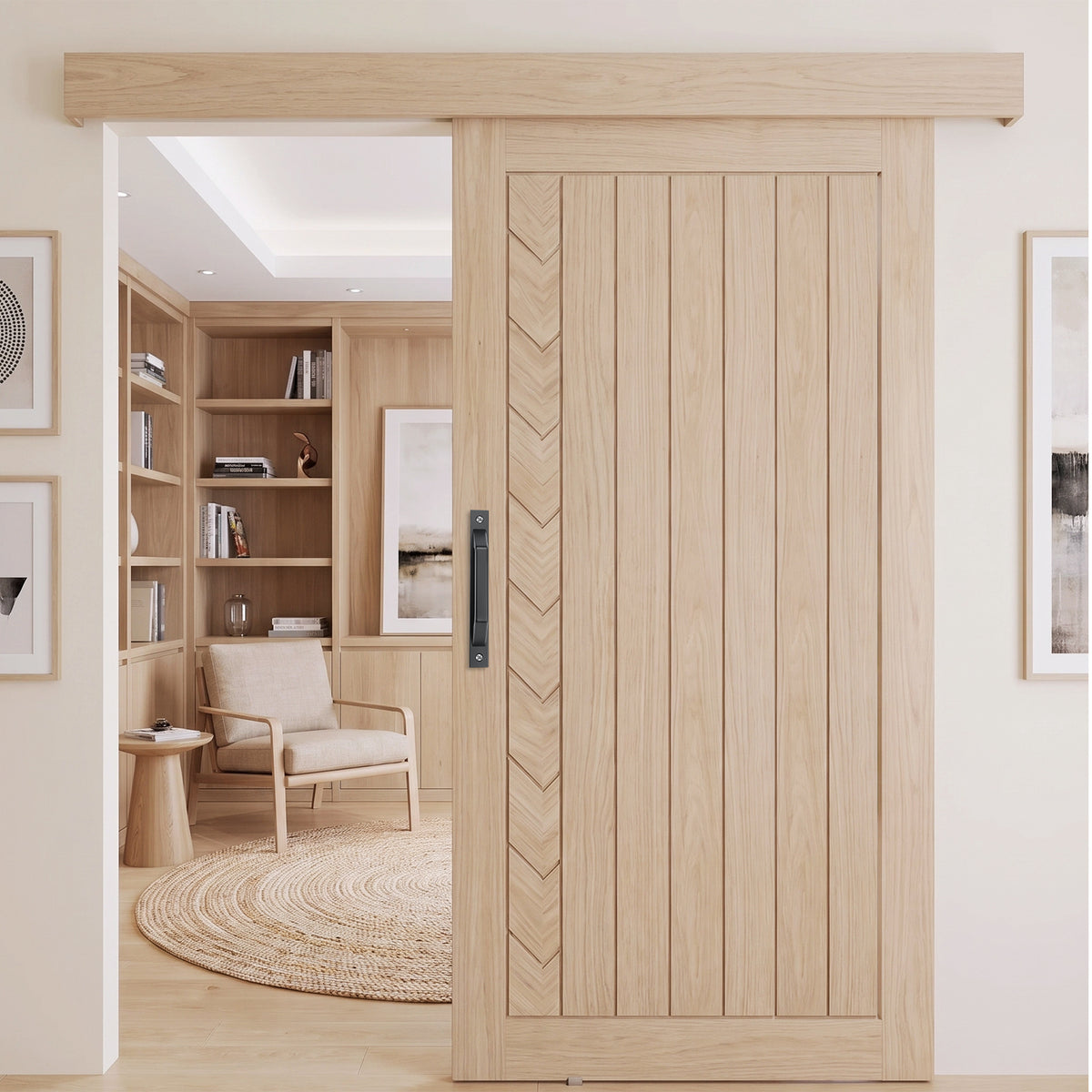 A light natural wood sliding door with vertical panels and a chevron inlay, shown installed in a modern home interior with a built-in bookshelf and chair visible through the opening.