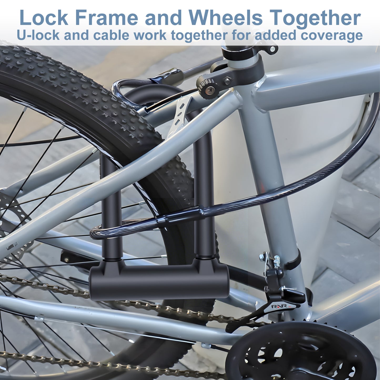 Bicycle locked with a U-lock and cable on a blurred indoor background