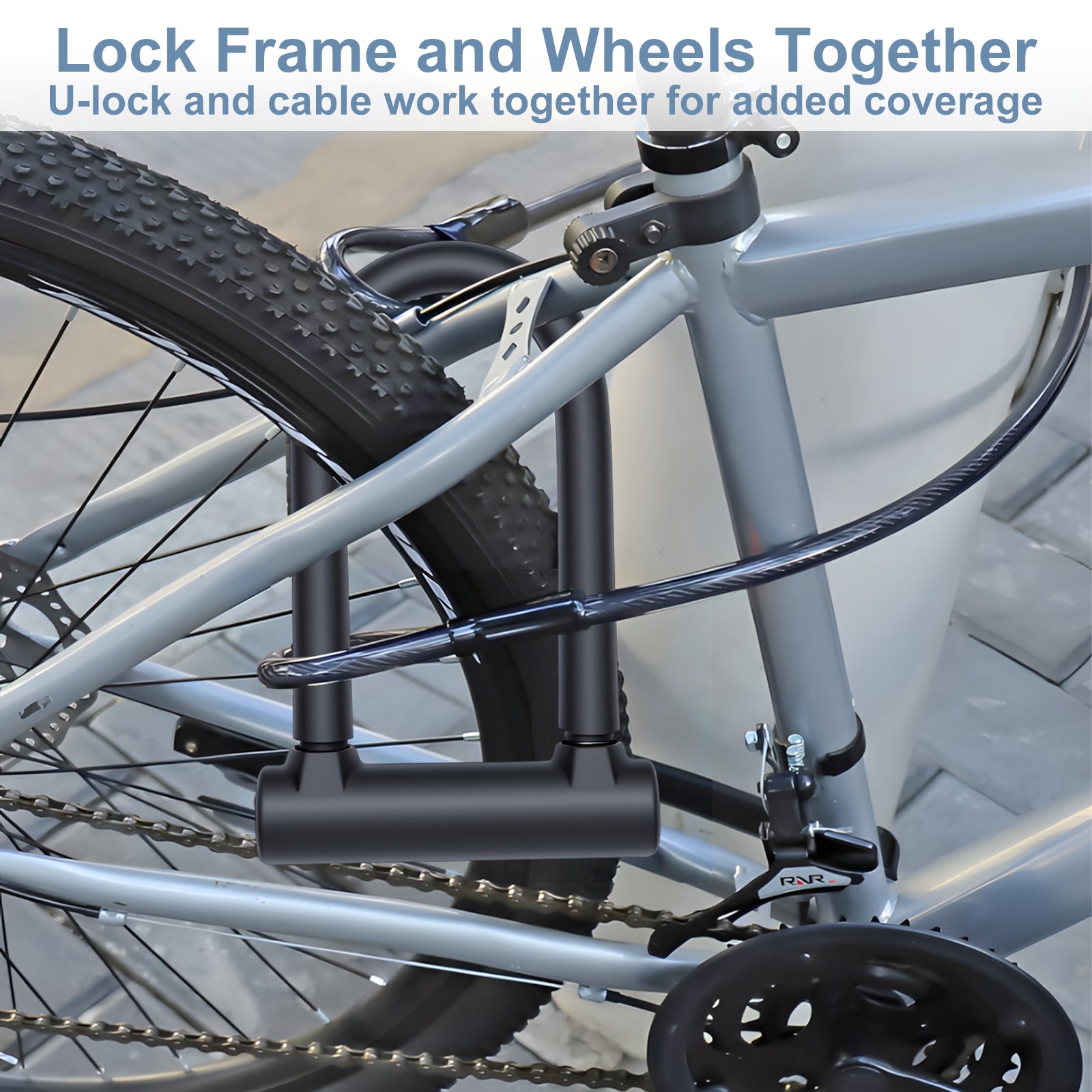 Bicycle locked with a U-lock and cable on a blurred indoor background