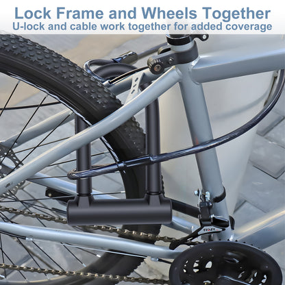 Bicycle locked with a U-lock and cable on a blurred indoor background