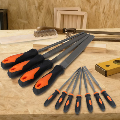 Set of rasp tools with orange and black handles on a wooden surface