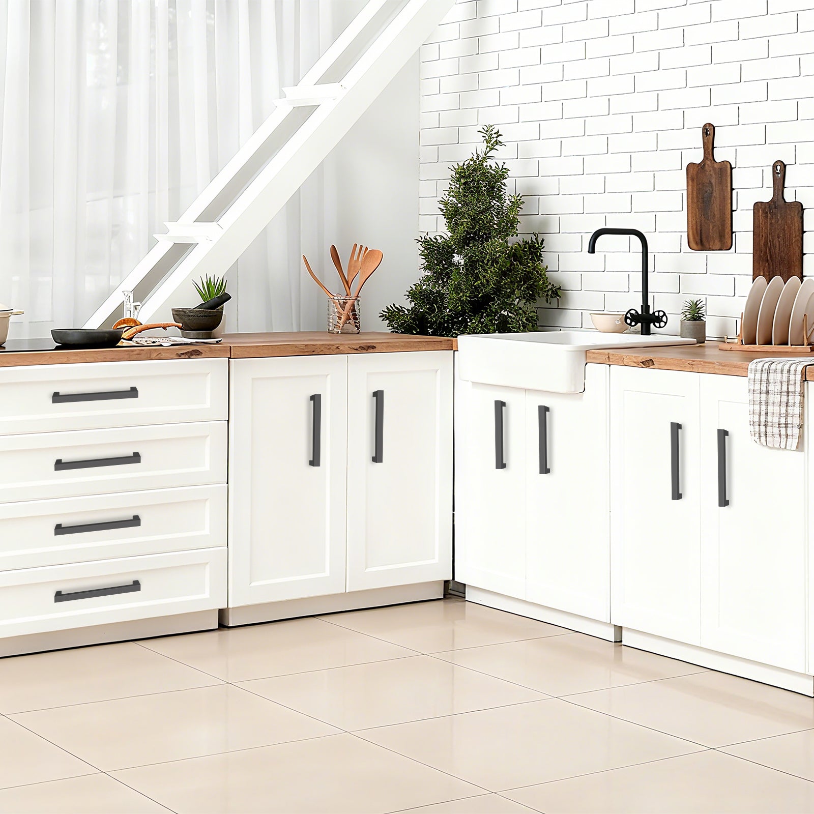 Modern kitchen with white cabinets, wooden countertops, and a Christmas tree.