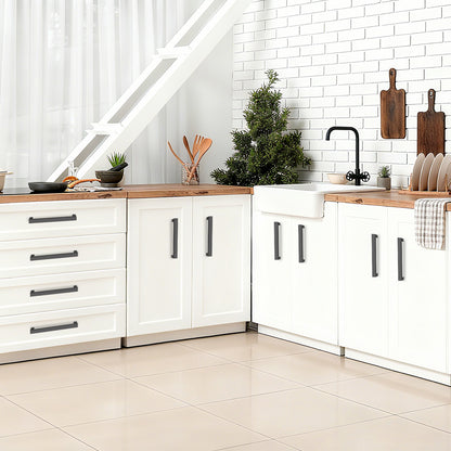 Modern kitchen with white cabinets, wooden countertops, and a Christmas tree.