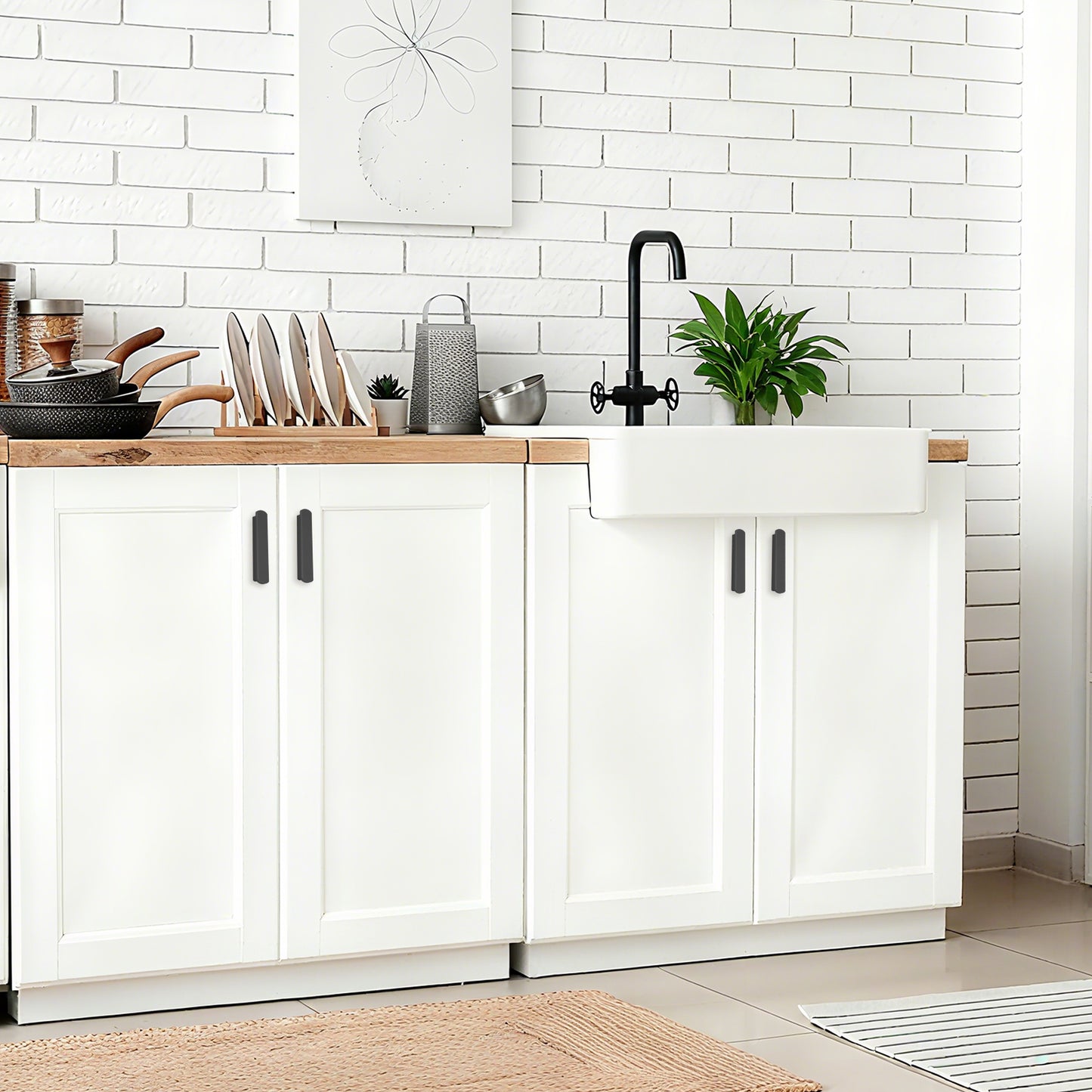 Modern kitchen with white cabinets, wooden countertop, and black fixtures.