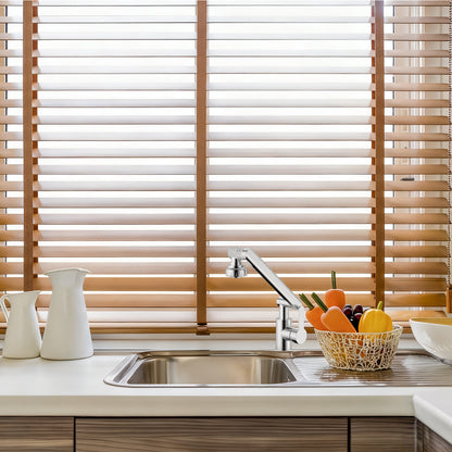 Kitchen sink with wooden blinds in the background