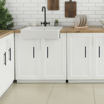 Modern kitchen with white cabinets, wooden countertops, and a white sink.