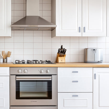 Modern kitchen with stainless steel appliances and white cabinets.