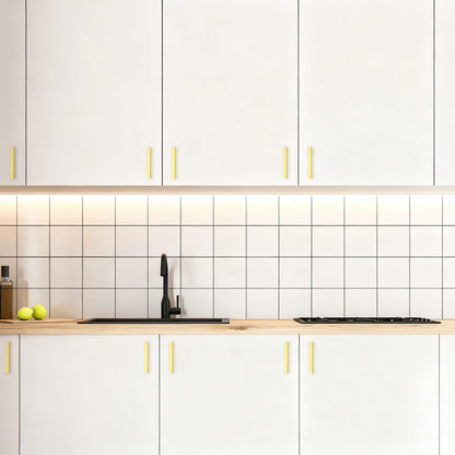 Modern kitchen with white cabinets, wooden countertops, and a tiled backsplash.