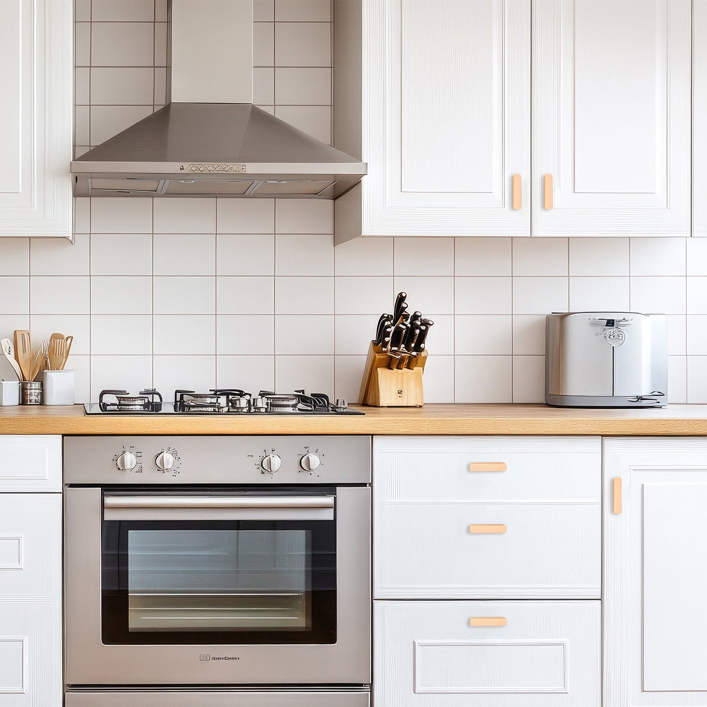 Modern kitchen with stainless steel appliances and white cabinets.