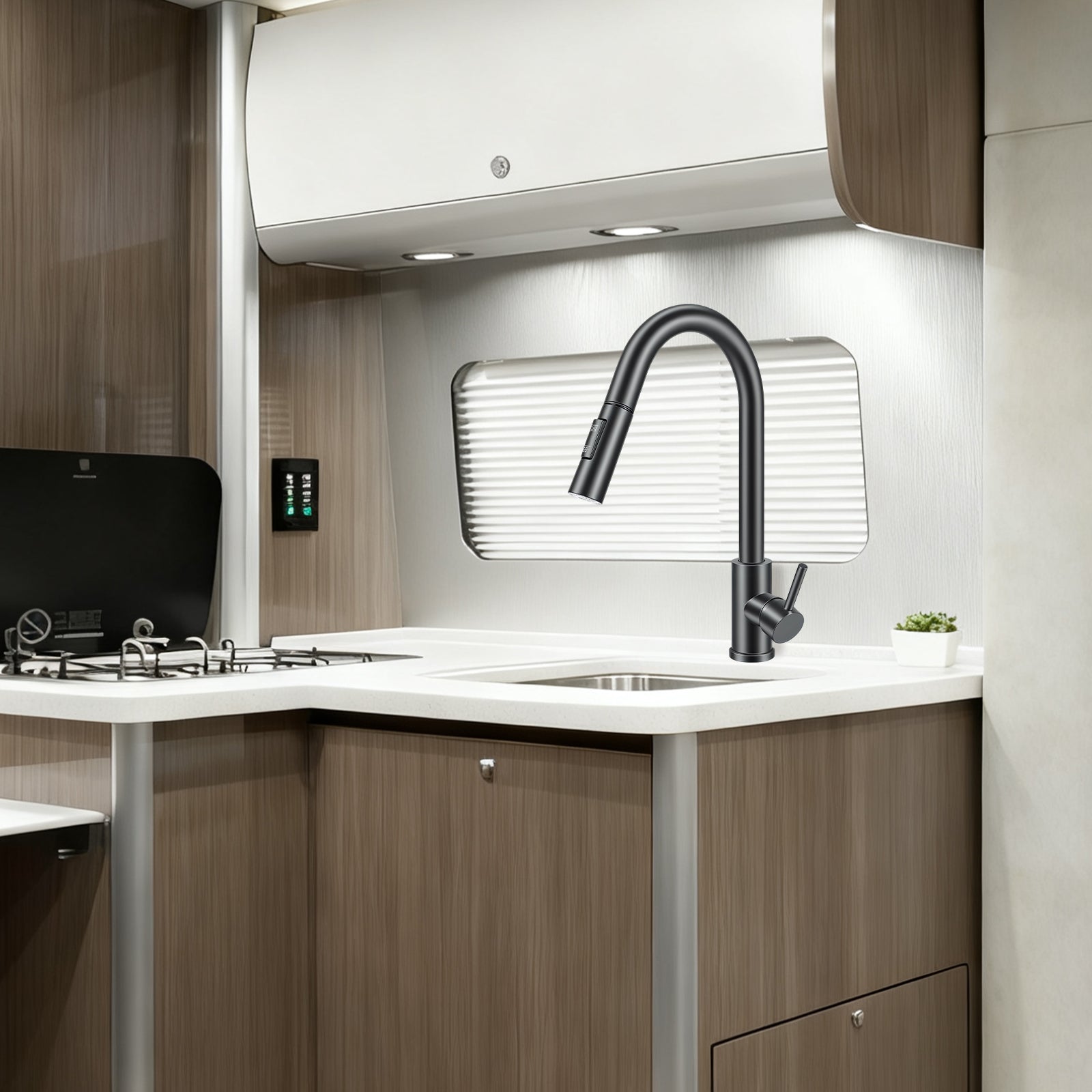 Modern kitchen interior with a sink, faucet, and wooden cabinets.