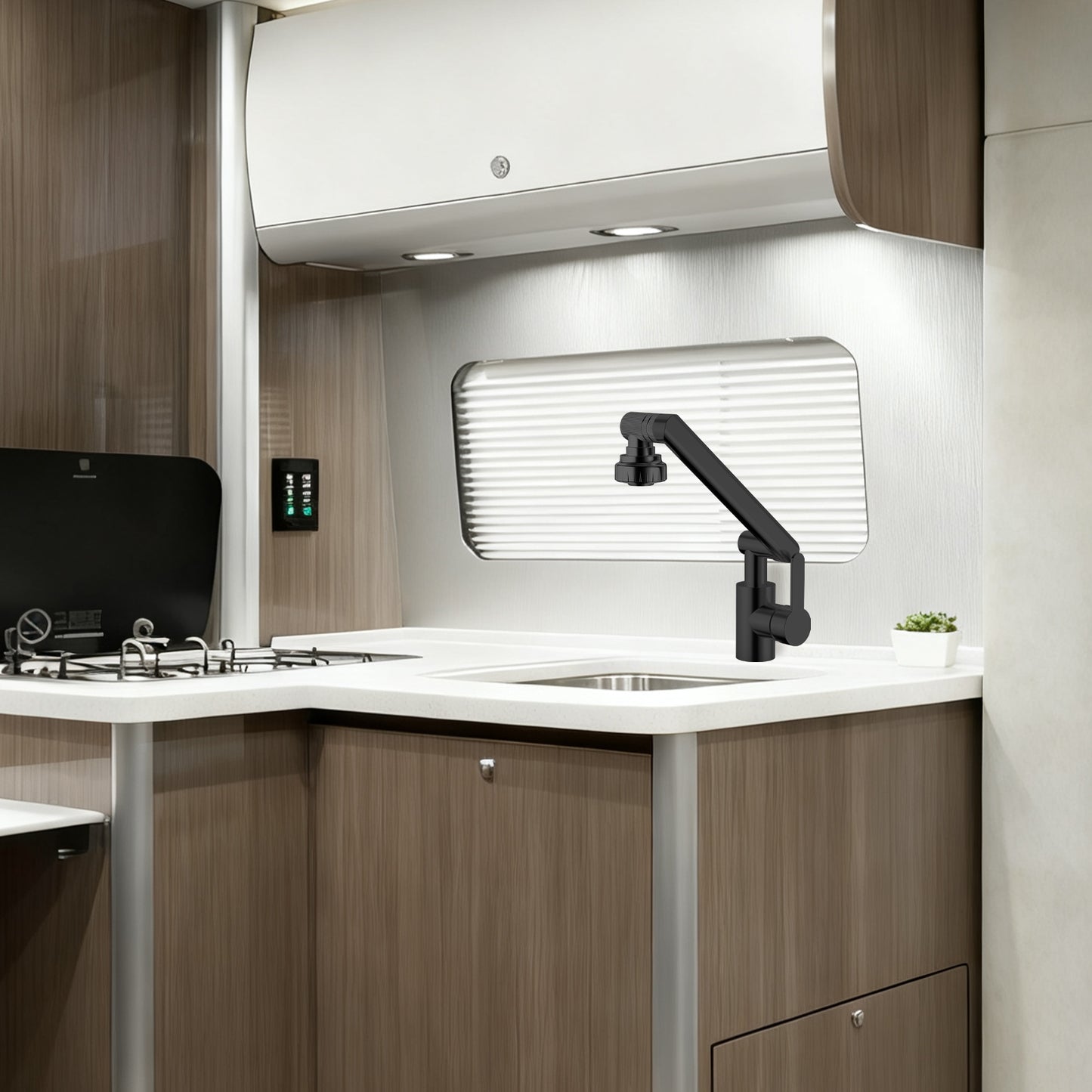 Modern kitchenette with sink, stove, and cabinets in a compact space