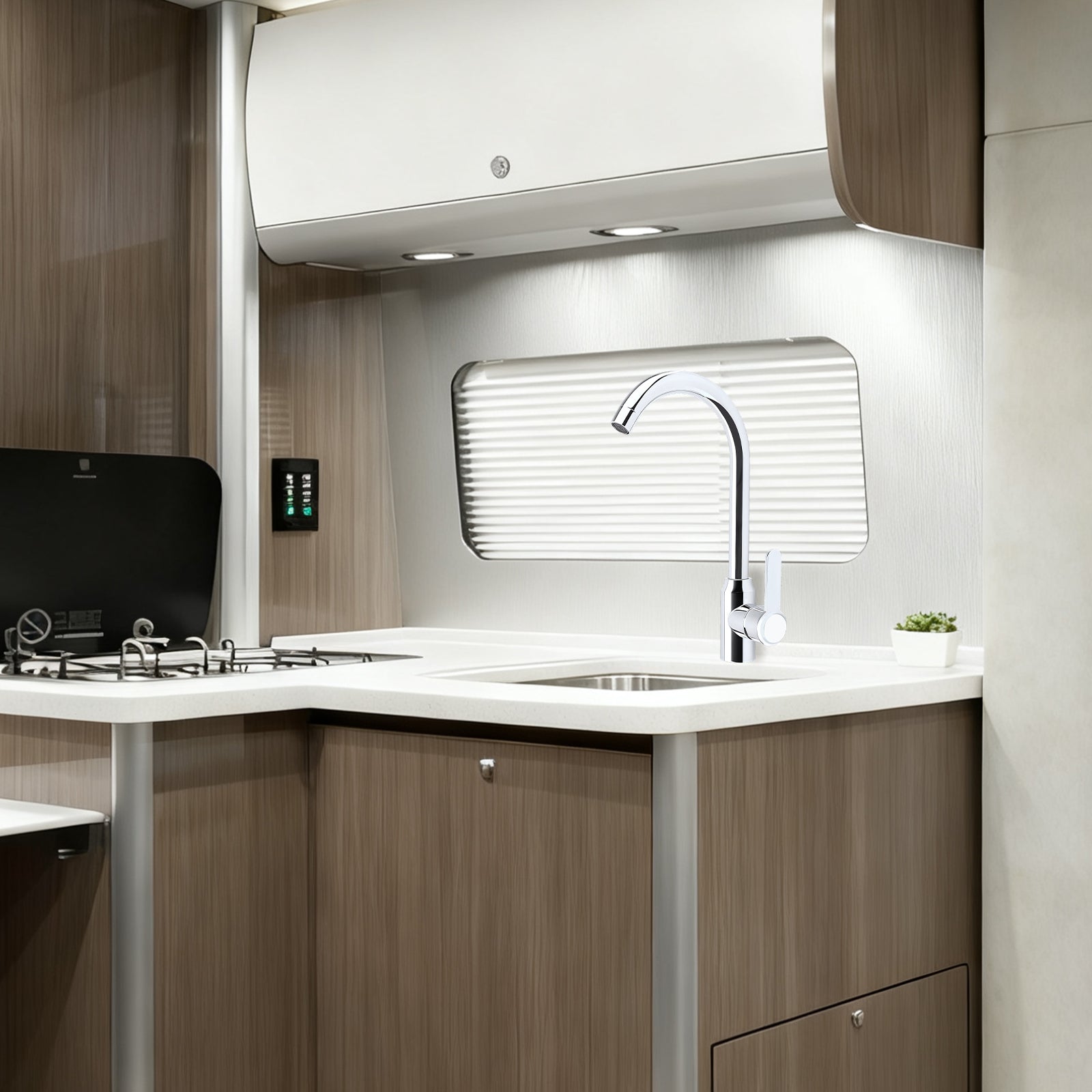 Modern kitchen interior with sink, faucet, and wooden cabinets.