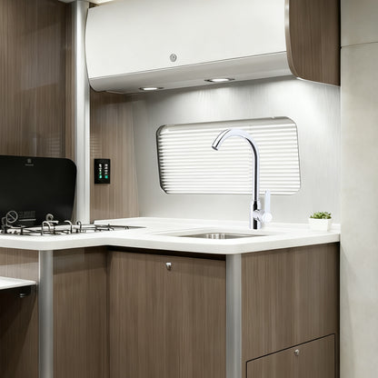 Modern kitchen interior with sink, faucet, and wooden cabinets.
